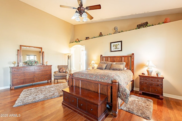 bedroom featuring hardwood / wood-style flooring, lofted ceiling, and ceiling fan