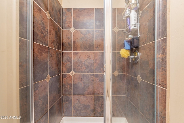 bathroom with a tile shower