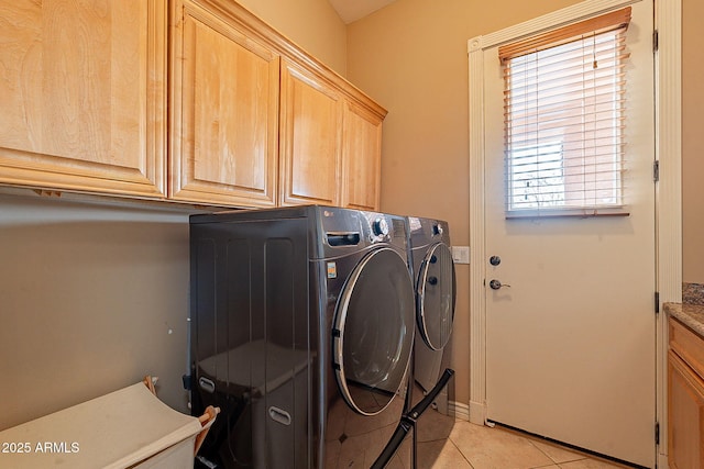 washroom featuring cabinets, light tile patterned floors, and independent washer and dryer