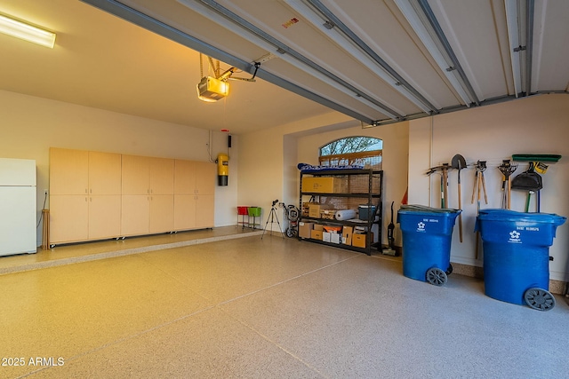 garage featuring a garage door opener and white refrigerator