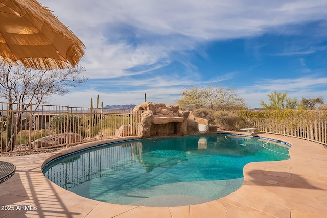 view of swimming pool with a patio and a diving board