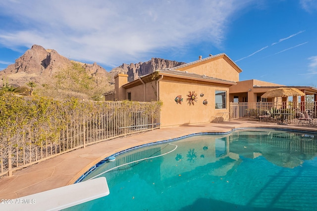 view of pool with a mountain view and a patio