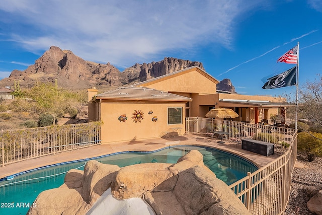 view of pool with a mountain view and a patio