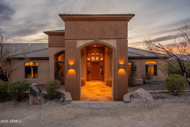 view of exterior entry at dusk