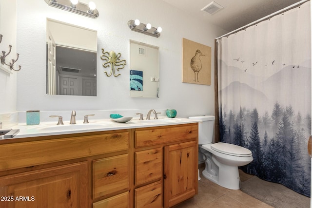 bathroom featuring tile patterned floors, toilet, and vanity