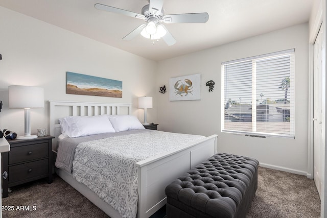 bedroom featuring ceiling fan, dark carpet, and a closet