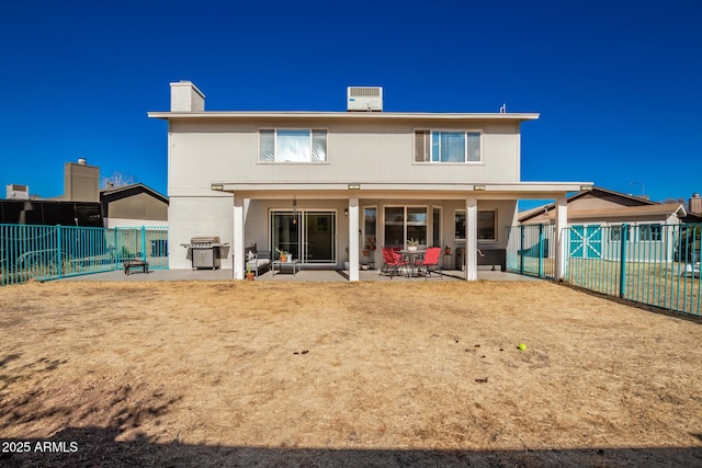 rear view of property featuring a patio