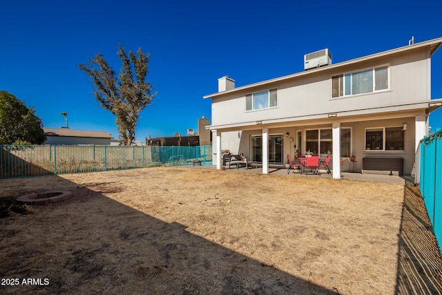 rear view of house with cooling unit and a patio area