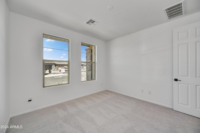 empty room featuring light carpet