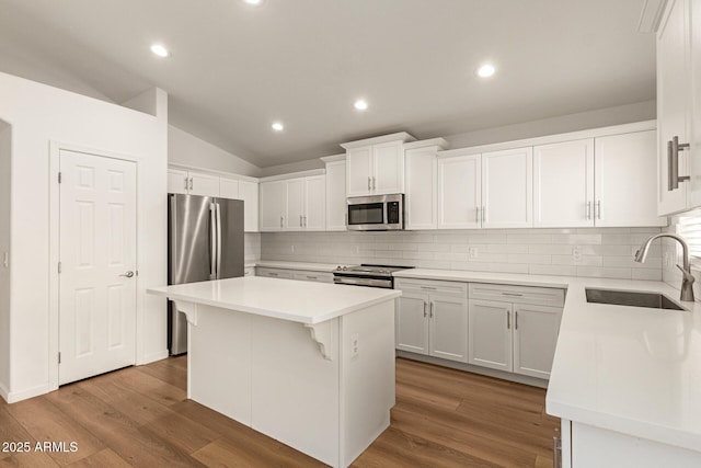 10212 E Caballero St, Mesa, AZ 85207 - kitchen featuring stainless steel appliances, light countertops, white cabinets, tasteful backsplash, and lofted ceiling