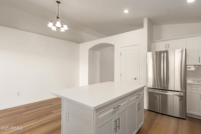 10212 E Caballero St, Mesa, AZ 85207 - kitchen featuring freestanding refrigerator, recessed lighting, light countertops, wood finished floors, and arched walkways