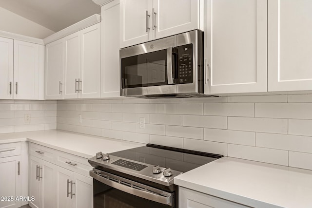 10212 E Caballero St, Mesa, AZ 85207 - kitchen with stainless steel appliances, decorative backsplash, white cabinetry, and light countertops