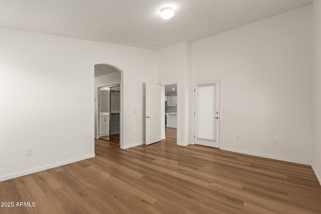 10212 E Caballero St, Mesa, AZ 85207 - unfurnished bedroom with arched walkways, wood finished floors, and a spacious closet