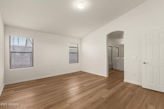 10212 E Caballero St, Mesa, AZ 85207 - spare room with arched walkways, light wood finished floors, and lofted ceiling
