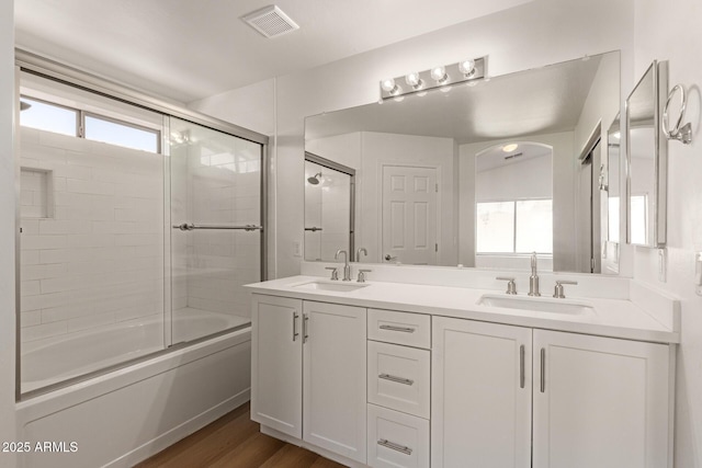 10212 E Caballero St, Mesa, AZ 85207 - bathroom featuring double vanity, shower / bath combination with glass door, and wood finished floors