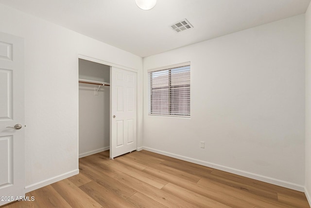 10212 E Caballero St, Mesa, AZ 85207 - unfurnished bedroom with light wood finished floors and a closet