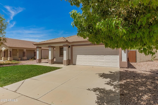 10212 E Caballero St, Mesa, AZ 85207 - view of front of property featuring a garage, stucco siding, driveway, a tile roof, and a front lawn