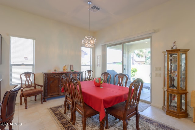 tiled dining area with a notable chandelier