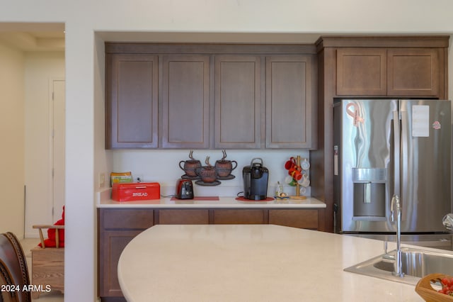 kitchen featuring sink and stainless steel fridge with ice dispenser