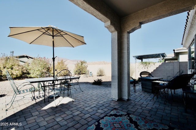 view of patio featuring a fenced backyard, a mountain view, a pergola, and outdoor dining space