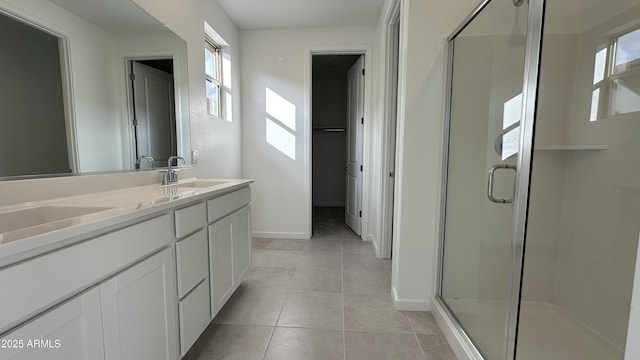 bathroom with tile patterned floors, vanity, and an enclosed shower