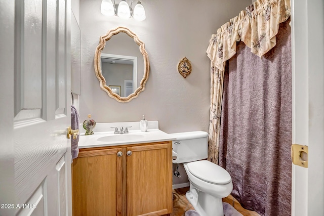 bathroom with toilet and vanity