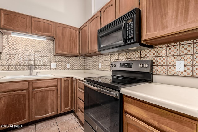 4313 N 29th Way, Phoenix, AZ 85016 - kitchen with stainless steel range with electric cooktop, black microwave, a sink, light countertops, and decorative backsplash