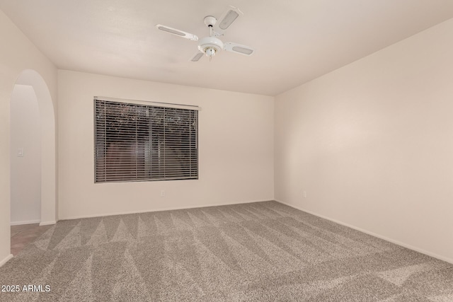 4313 N 29th Way, Phoenix, AZ 85016 - unfurnished room with carpet floors, arched walkways, a ceiling fan, and baseboards