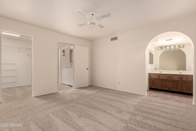 4313 N 29th Way, Phoenix, AZ 85016 - unfurnished bedroom featuring a spacious closet, washer and dryer, light colored carpet, and connected bathroom