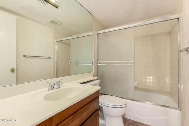 4313 N 29th Way, Phoenix, AZ 85016 - bathroom featuring vanity, toilet, enclosed tub / shower combo, and tile patterned flooring