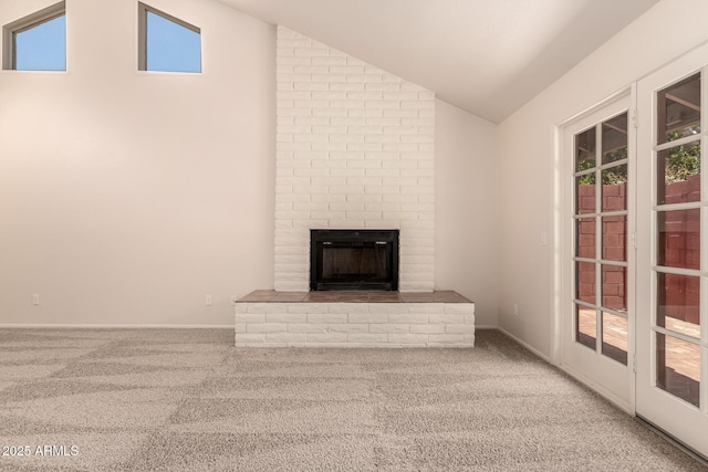 4313 N 29th Way, Phoenix, AZ 85016 - unfurnished living room with vaulted ceiling, carpet floors, a brick fireplace, and baseboards
