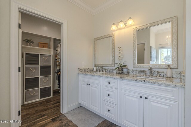 bathroom featuring vanity, hardwood / wood-style floors, and crown molding