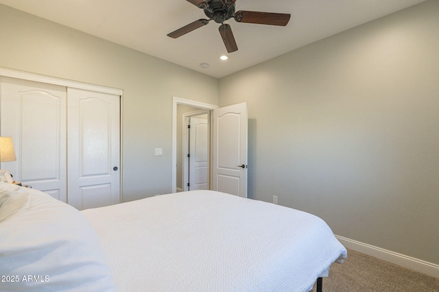 carpeted bedroom featuring ceiling fan and a closet