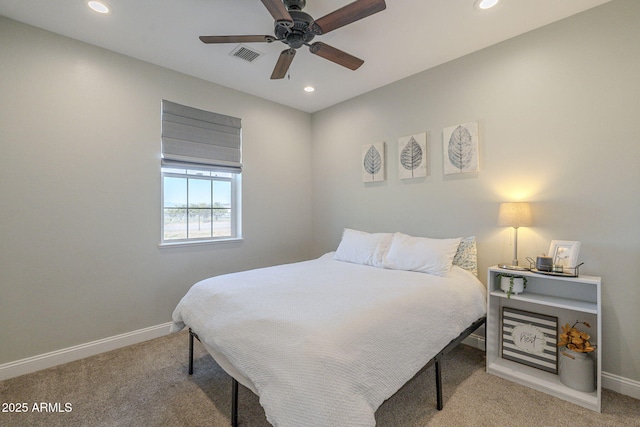 bedroom with ceiling fan and light carpet