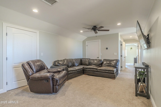 living room with ceiling fan, light colored carpet, and vaulted ceiling