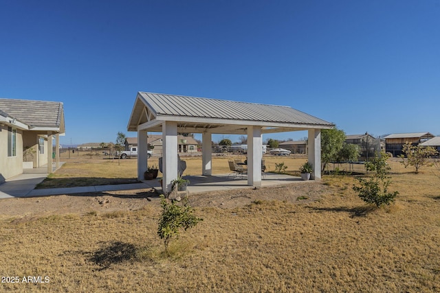 view of property's community with a gazebo, a patio, and a yard