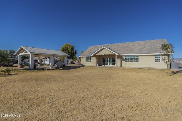 single story home with central AC, a front lawn, and a gazebo