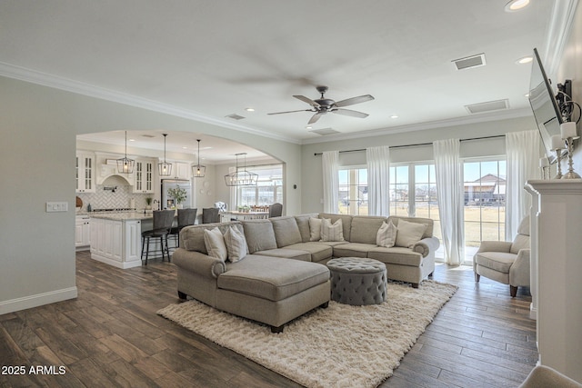 living room with ornamental molding, ceiling fan with notable chandelier, and dark hardwood / wood-style floors