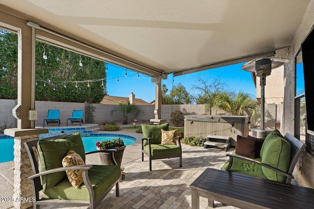 view of patio / terrace featuring a pool with hot tub