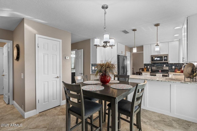 dining room featuring a textured ceiling