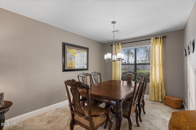 dining space with a chandelier