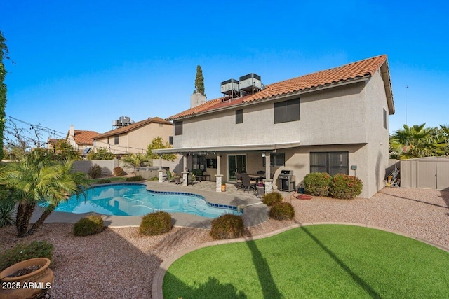 view of pool featuring a grill and a patio