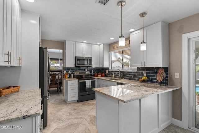 kitchen with sink, white cabinetry, hanging light fixtures, kitchen peninsula, and stainless steel appliances