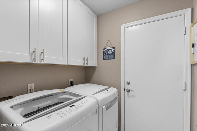 laundry area with cabinets and washing machine and dryer