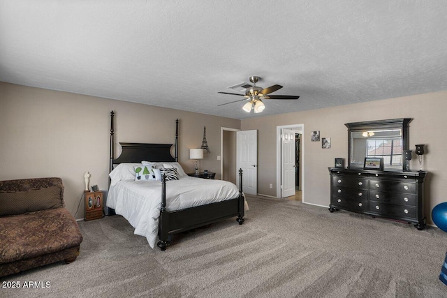 carpeted bedroom featuring ceiling fan and a textured ceiling