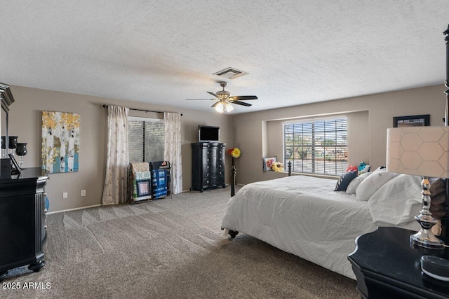 bedroom with ceiling fan, light carpet, and a textured ceiling