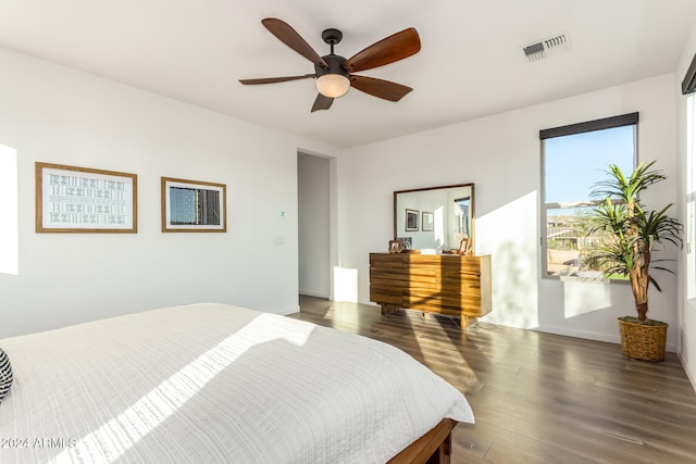 bedroom with dark hardwood / wood-style floors and ceiling fan