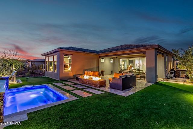 back house at dusk with an outdoor living space with a fire pit and a patio area