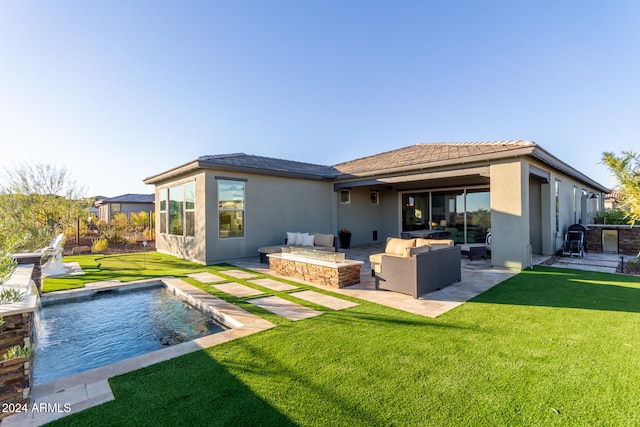 rear view of property with outdoor lounge area, a lawn, pool water feature, and a patio area