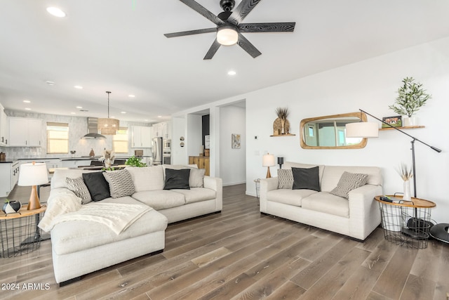 living room with hardwood / wood-style floors and ceiling fan